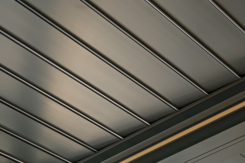 Closed aluminum pergola louvers and architectural perimeter frame.