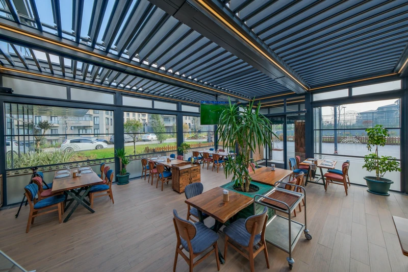 Commercial lounge beneath tilted Royal pergola louvers.