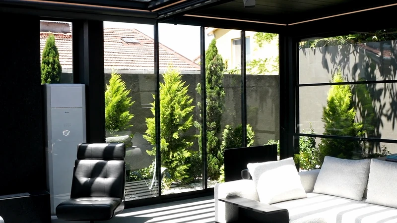 Railglass forming a clean glazed boundary around a covered interior lounge.