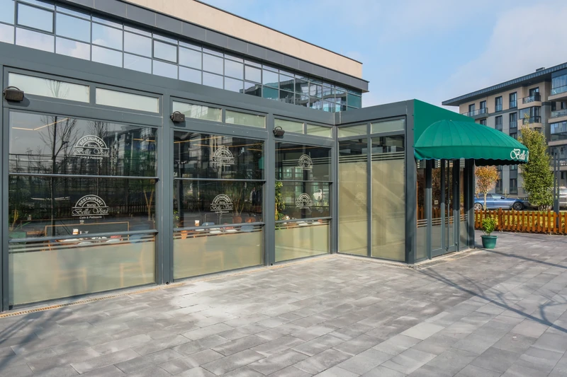 Upglass enclosure integrated into a commercial restaurant exterior.