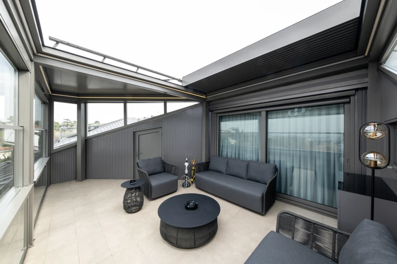 Royal pergola roof retracted above a residential terrace lounge.