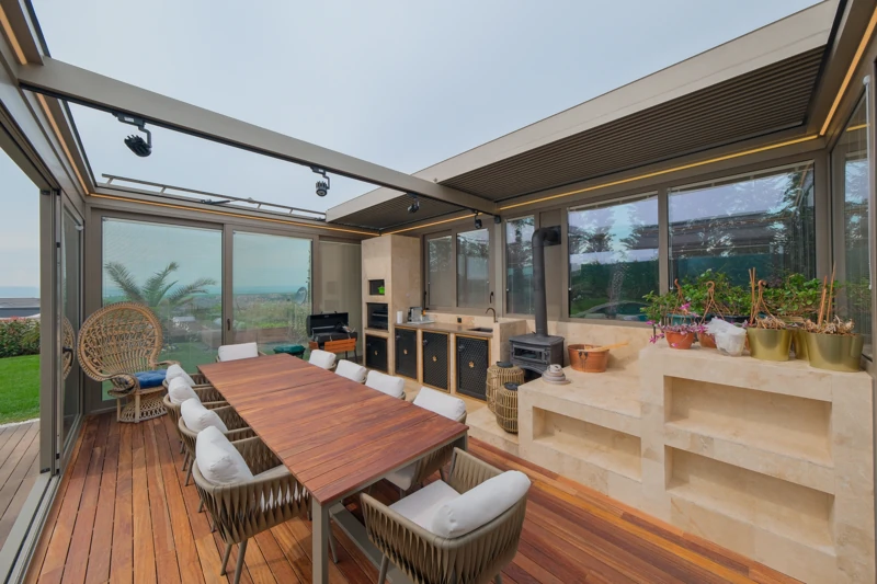A bioclimatic pergola opening a residential terrace to the sky.
