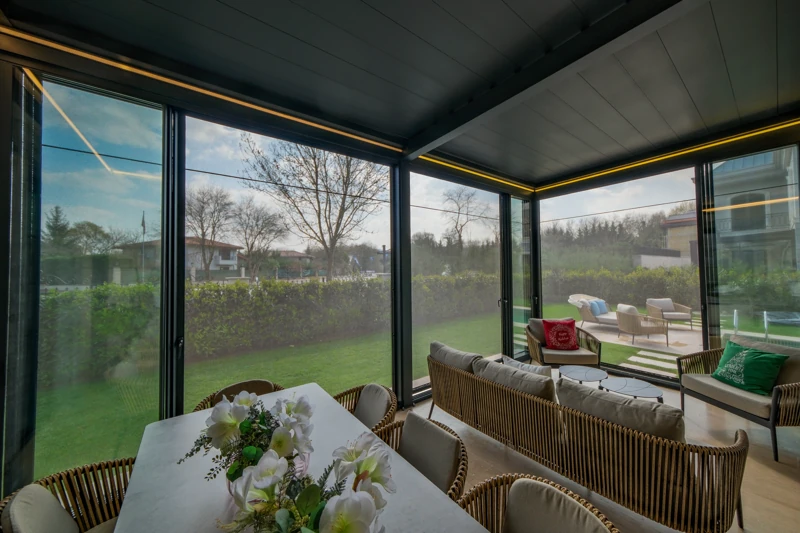 Filtered daylight inside a residential outdoor room with integrated Zip Blind shading.