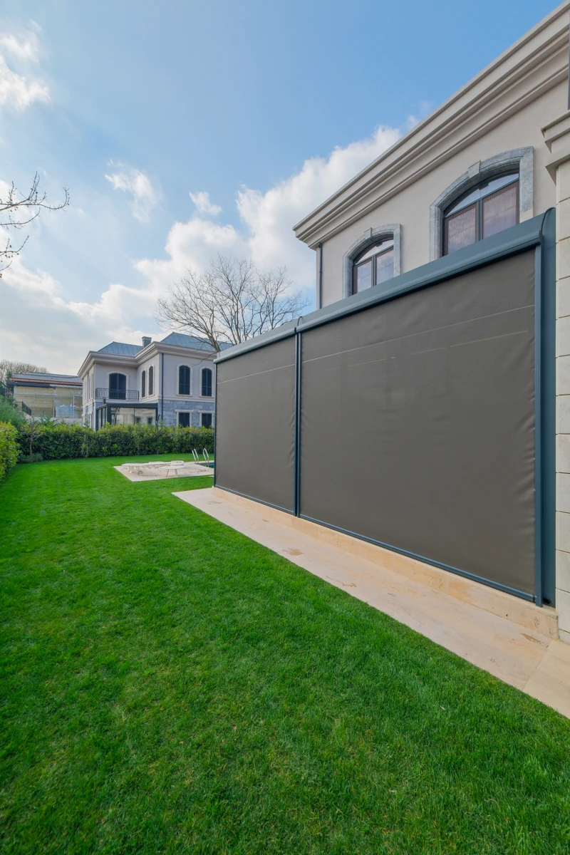 Zip Blind lowered along the side of a residential pergola.